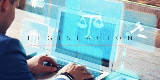 Imagen de perfil de una persona escribiendo en un ordenador portátil y donde se lee encima la palabra "legislación" junto al icono de una balanza y un mazo de juez